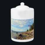 Vormsi Stillness Teapot<br><div class="desc">This artwork captures the quiet strength and timeless presence of Vormsi, a small Estonian island in the Baltic Sea. At its center stands the Saxby Lighthouse — not as a symbol of grandeur, but as a calm, steady guide surrounded by coastal silence. The composition draws on soft natural tones, minimal...</div>