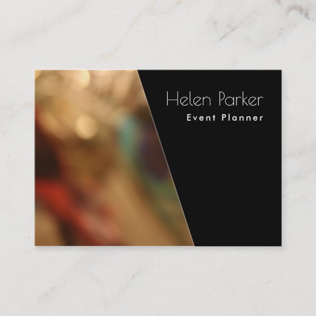 Warm, blurred photo beside solid black diagonal business card (Front)