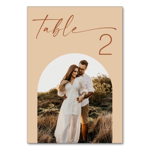 Warm Peach Sand Wedding | Modern Script Arch Photo Table Number