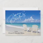 Warm Sunny Beach With Chairs Christmas Card<br><div class="desc">Warm holiday wishes from the beach. In a white script is says, "Merry Christmas". There's a bright blue sky an ocean and beautiful sand. The ocean with crystal blue water is crashing along the sand. There's 2 white chairs by the water. Check out the many other beach scenes and products...</div>