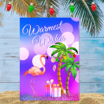 Warmest Wishes Flamingo Tropical Beach Christmas Holiday Card<br><div class="desc">This Warmest Wishes Christmas holiday greeting card features a pink flamingo with decorated holiday palm trees and gifts on a tropical lit beach night.  Inside Greeting ~ "From Our Holiday Paradise to Yours".  ^</div>