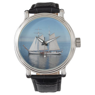 Watch with a photo pf a sail boat at sea