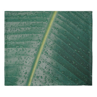 Water droplets on banana leaf duvet cover