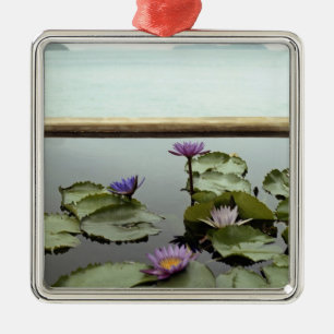 Water lilies in pond by ocean metal ornament
