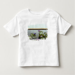 Water lilies in pond by ocean toddler t-shirt