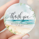 Watercolor Beach Wedding Thank You Classic Round Sticker<br><div class="desc">Watercolor Beach Wedding Thank You Classic Round Sticker. This design features a beautiful watercolor summer beach scene. Ocean waves,  sand and flowers are all featured in this tropical design.</div>