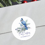 Watercolor Christmas Blue Jay Winter Holiday Classic Round Sticker<br><div class="desc">Use these beautiful snowy personalized Christmas stickers as envelopes seals or on holiday gifts,  featuring a gorgeous watercolor blue jay perched on a snow-covered pine branch,  decorated with sprigs of blue berries.</div>