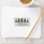 Watercolor Christmas Tree Farm Gray Return Address Label<br><div class="desc">Festive custom holiday address label design features a rustic chic winter scene from a Christmas tree farm and a snowy gray winter background. Includes a row of green watercolor painted pine trees with string lights. Personalize the simple charcoal gray wording with your family's return address text. Makes a beautiful accent...</div>