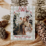 Watercolor Gingham Family Photo Christmas Holiday Card<br><div class="desc">Celebrate the season with this cozy and cheerful Christmas card featuring a hand-drawn red bow and soft sage green plaid background. The arched photo on the front is wrapped in whimsical charm, while the back includes a watercolor greenery frame with space for four photos and a heartfelt holiday message. A...</div>