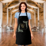 Watercolor Greenery Leaves Black Gold Monogram Apron<br><div class="desc">Elegant watercolor greenery leaves floral monogram name apron featuring a gold monogram initial on a black background with your name set modern white lettering. Designed by Thisisnotme©</div>