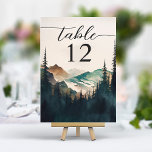 Watercolor Mountains Pine Forest Wedding Table Number<br><div class="desc">Ensure a seamless seating arrangement with the Watercolor Mountains Pine Forest Wedding Table Number. This card, printed on high-quality card stock, features a serene watercolor scene of mountains and a pine forest, setting a tranquil tone for your tablescape. The table number is prominently displayed in clear, modern typography, ensuring easy...</div>