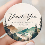 Watercolor Mountains Pine Forest Wedding Thank You Classic Round Sticker<br><div class="desc">Seal your gratitude with the tranquil beauty of the Watercolor Mountains Pine Forest Wedding Thank You Classic Round Sticker. This sticker, printed on durable material, features a serene watercolor scene of mountains and a pine forest. A heartfelt 'Thank You' message, written in modern typography, graces the center of the sticker....</div>