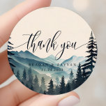 Watercolor Pine Tree Mountain Wedding Thank You Classic Round Sticker<br><div class="desc">Express your gratitude with a touch of rustic elegance using the Watercolor Pine Tree Mountain Wedding Thank You Classic Round Sticker. This sticker, printed on durable material, depicts a tranquil watercolor scene of pine trees and mountains. A heartfelt 'Thank You' message, written in modern typography, graces the center of the...</div>