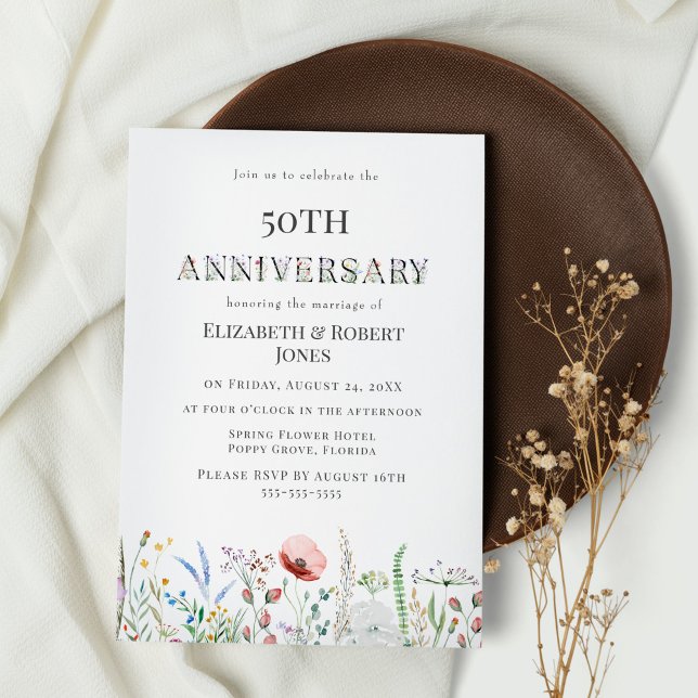 Watercolor Wildflower 50th Anniversary Party Invitation (Boho Wildflowers Anniversary Party Invitation on white table with dark brown plate)