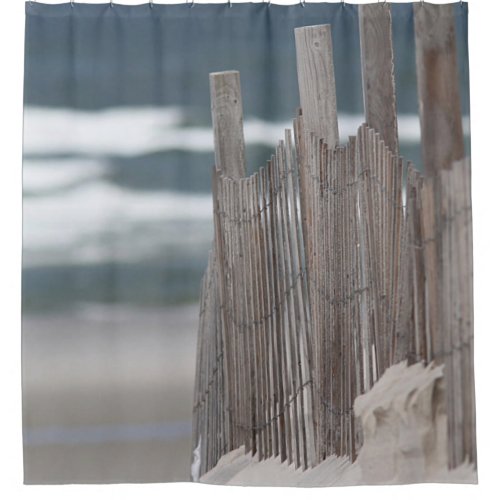 Weathered fence in the sand at the beach shower curtain