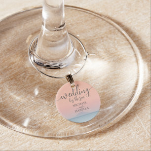 Wedding by the sea under peachy sky sunset wine charm