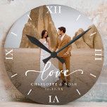 Wedding Photo Love Script Anniversary Round Clock<br><div class="desc">Celebrate love with our personalized wedding photo love script anniversary round clock,  which features an elegant script and chic modern design. This personalized photo clock beautifully displays your favorite wedding photo,  making it a timeless keepsake for newlyweds or a thoughtful wedding anniversary gift!</div>