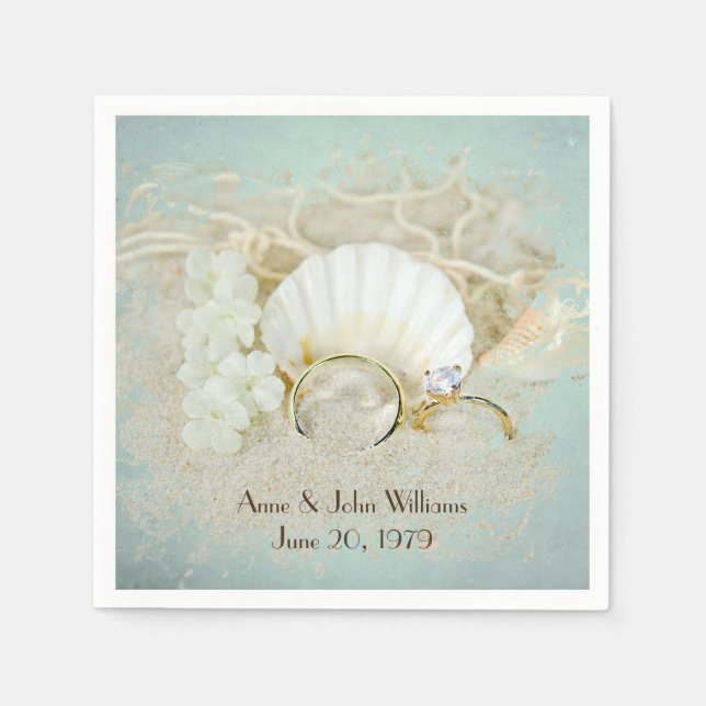 wedding rings and seashells in sand napkins (Front)