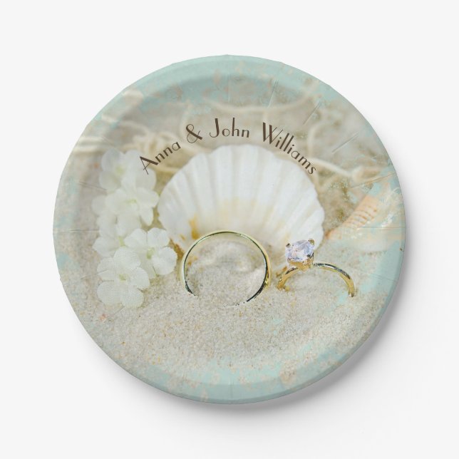 wedding rings and seashells in sand with net paper plates (Front)
