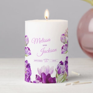Wedding stock purple flowers on white pillar candle
