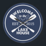 Welcome to the Lake House | Canoe Paddles Large Clock<br><div class="desc">You may be on lake time, but a clock is still a practical choice. Our customized creation in classic navy blue and white features "Welcome to the Lake House" in destroyed vintage typeface with two crossed canoe paddles and a rope illustration. Customize with the year you started life at the...</div>