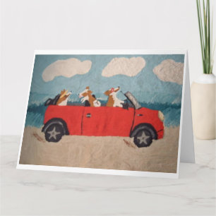 Welsh Corgis in a red convertible at the beach Card