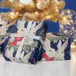 Whimsical Christmas Bunny Rabbits Snow Winter Blue Wrapping Paper<br><div class="desc">A whimsical and unique quality wrapping paper for the Christmas and winter holidays! On a dramatic dark blue background, a pair of snuggly white bunny rabbits peer over a festive greenery swag filled with holly, yew and snow berries. Mr. Bun sports a red scarf and Ms. Bun wears a snow...</div>