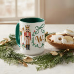 Whimsical Christmas Nutcracker Monogram Bow Mug<br><div class="desc">Celebrate the season with our whimsical nutcracker Monogram Mug — a perfect blend of festive charm and personalized elegance. This enchanting design features our hand-drawn holiday florals surrounding a beautifully illustrated floral leaf crest, personalized with your custom monogram and topped with an elegant green striped bow. Flanking the crest are...</div>