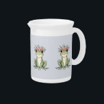 Whimsical Floral Frog Cottagecore Art Beverage Pitcher<br><div class="desc">This charming floral frog illustration captures the essence of cottagecore whimsy with its delicate balance of nature and enchantment. Featuring an adorable green frog crowned with a wreath of soft pink blossoms and leafy accents, this design radiates peaceful woodland charm. The hand-drawn details and gentle pastel tones make it a...</div>