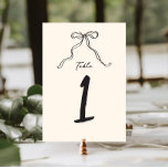 Whimsical Quirky Handwritten Bow Table Number<br><div class="desc">Whimsical bridal shower table number featuring a beautiful hand-drawn bow in a fun and playful style,  accompanied by a casual,  handwritten font that perfectly captures the excitement and joy of the occasion.
The welcome sign comes in a neutral color scheme of forest dark gray on ecru.</div>