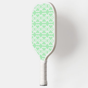 White abstract shapes on green pickleball paddle