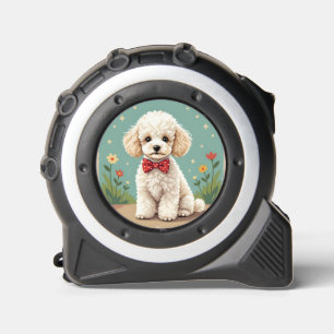 White adorable poodle with bow tie tape measure