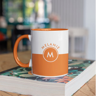 White and orange split-screen monogram mug