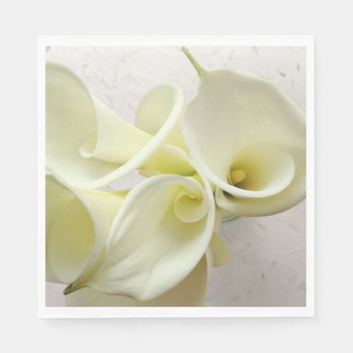 White calla lilies from above napkins