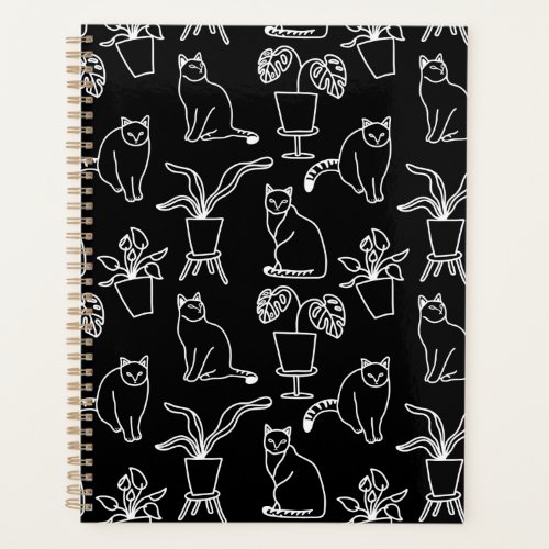 White cats on black planner