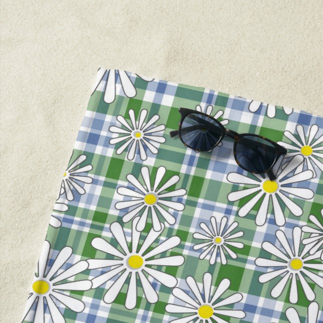 White chamomile flowers on a green blue checkered  beach towel (In Situ)
