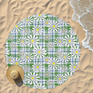 White chamomile flowers on a green blue checkered beach towel