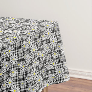 White chamomile flowers on black white checkered b tablecloth