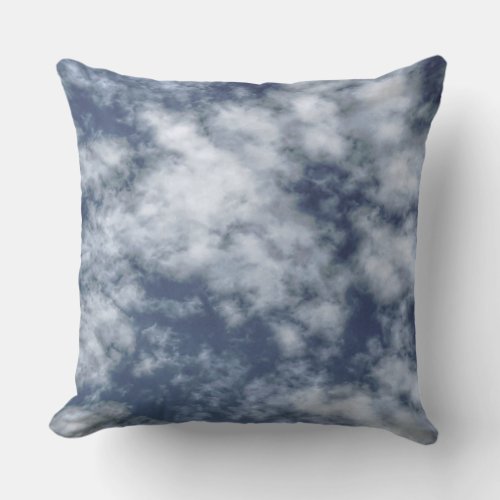 White clouds against blue sky on throw pillow