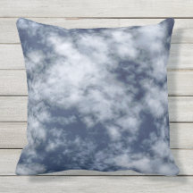 White clouds against blue sky on throw pillow