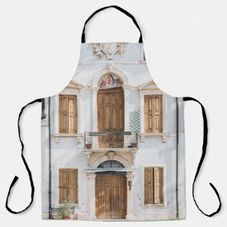 WHITE CONCRETE BUILDING WITH WOODEN DOORS AND WIND APRON