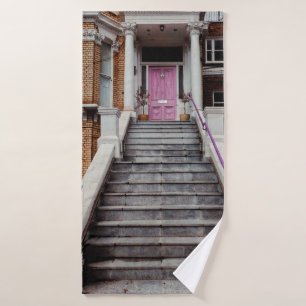 WHITE CONCRETE HOUSE SHOWING CLOSED PURPLE WOODEN  BATH TOWEL