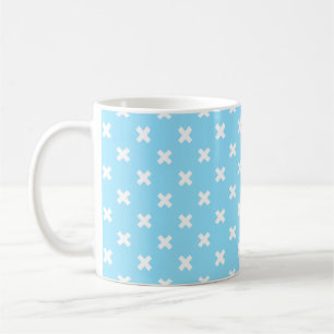 White cross stitches on baby blue coffee mug
