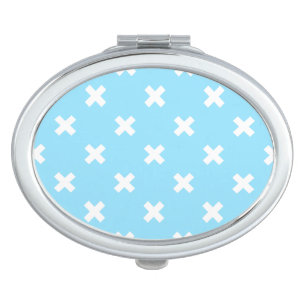 White cross stitches on baby blue compact mirror