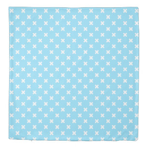 White cross stitches on baby blue duvet cover