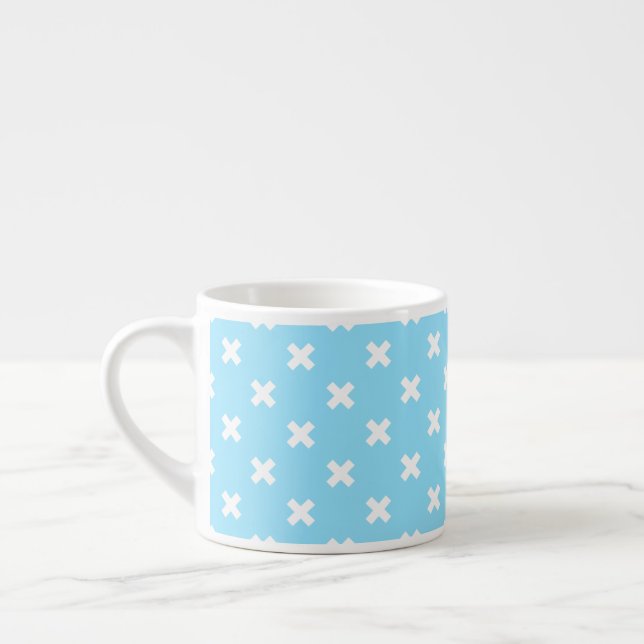 White cross stitches on baby blue espresso cup (Left)