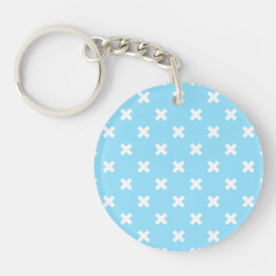 White cross stitches on baby blue keychain