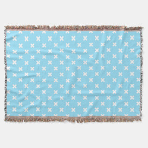White cross stitches on baby blue throw blanket