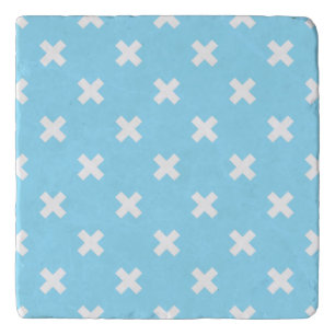 White cross stitches on baby blue trivet