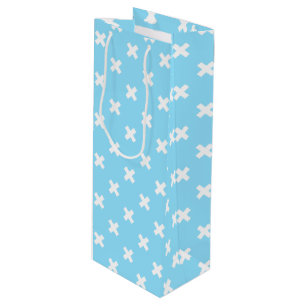 White cross stitches on baby blue wine gift bag